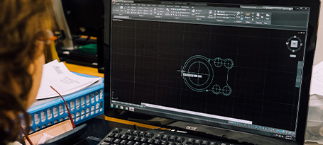 Aviron Technical Institute of Montreal Student drafting on a laptop.